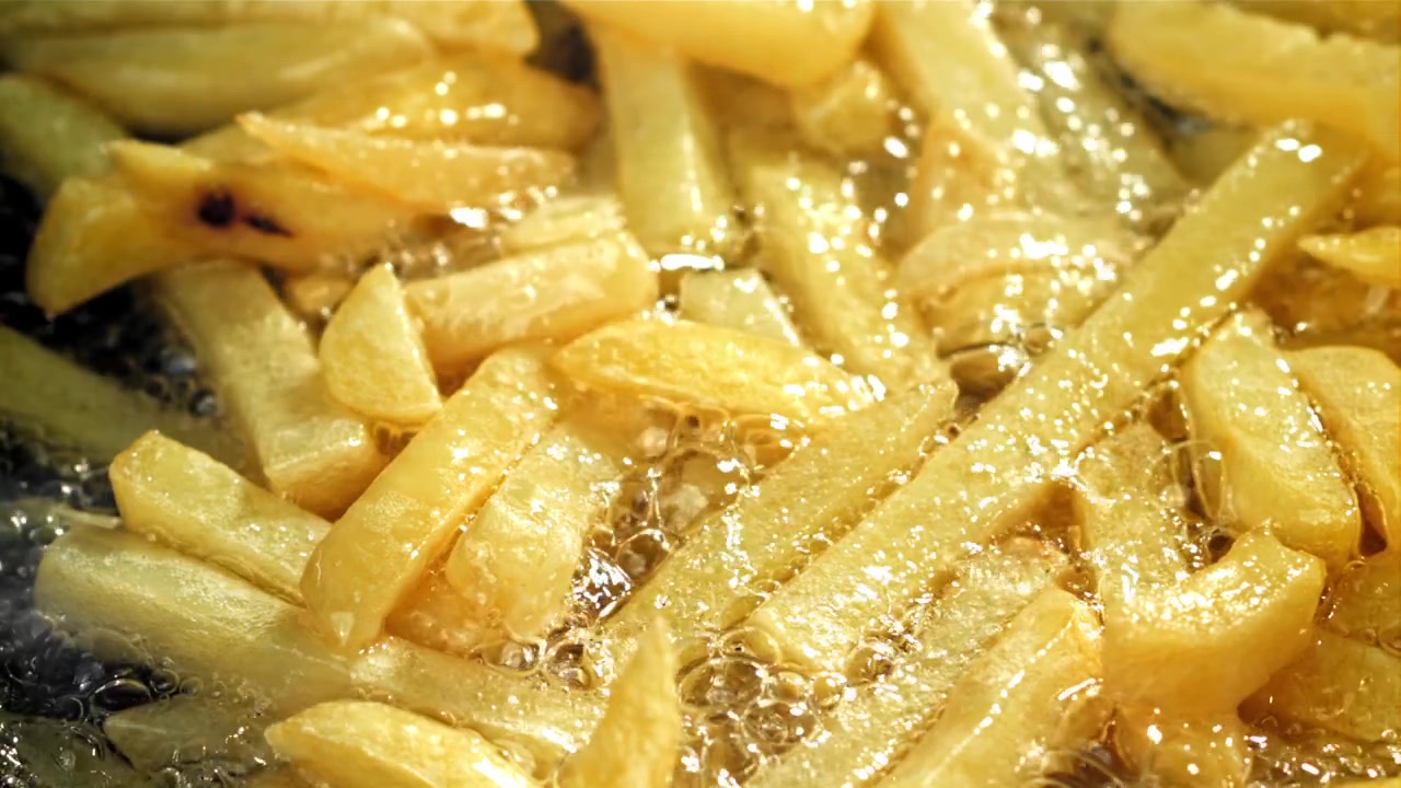 Gyllene potatispommes frites friteras i het olja