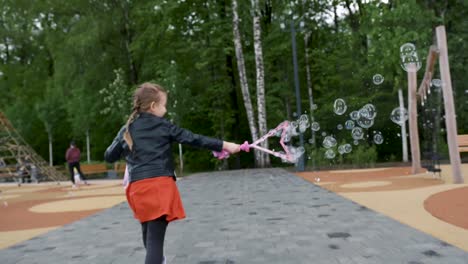 child playing with bubbles in park