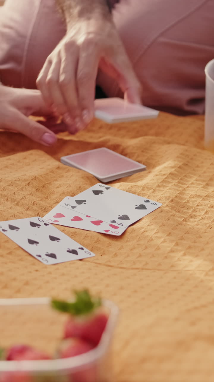 Friends Playing Cards at a Summer Picnic