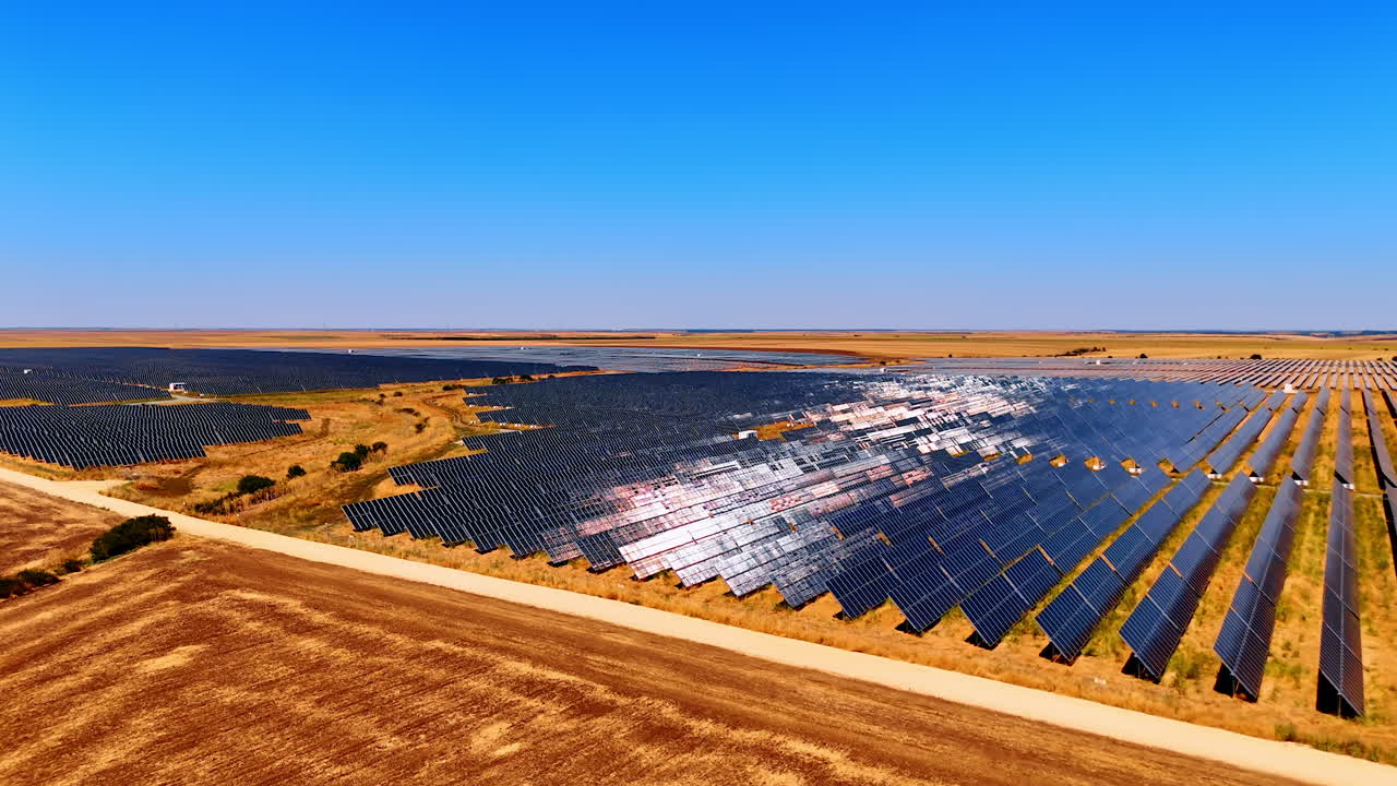 Huge solar station across farmland. Expansive farmland covered with solar panels for renewable energy production