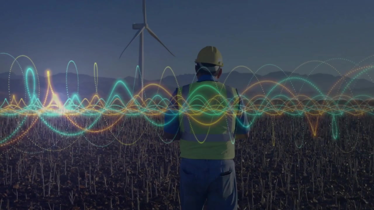 All'apparire di una forma d'onda, un ingegnere osserva le pulsazioni intorno a una turbina eolica per il monitoraggio energetico.