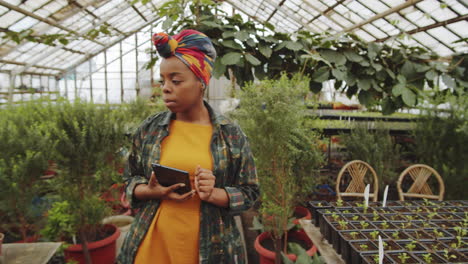 African-American-Female-Farmer-Working-on-Tablet-in-Greenhouse