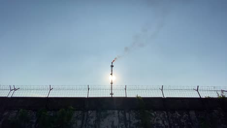 static establisher view of industry gas flare pipe burning, release smokestack