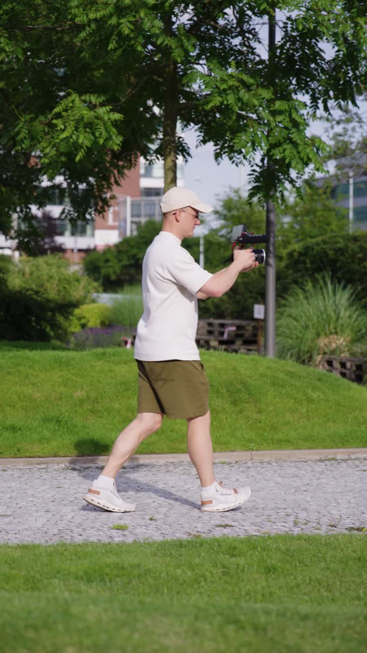 Premium stock video - Vertical shot of filmmaker slowly walk with ...
