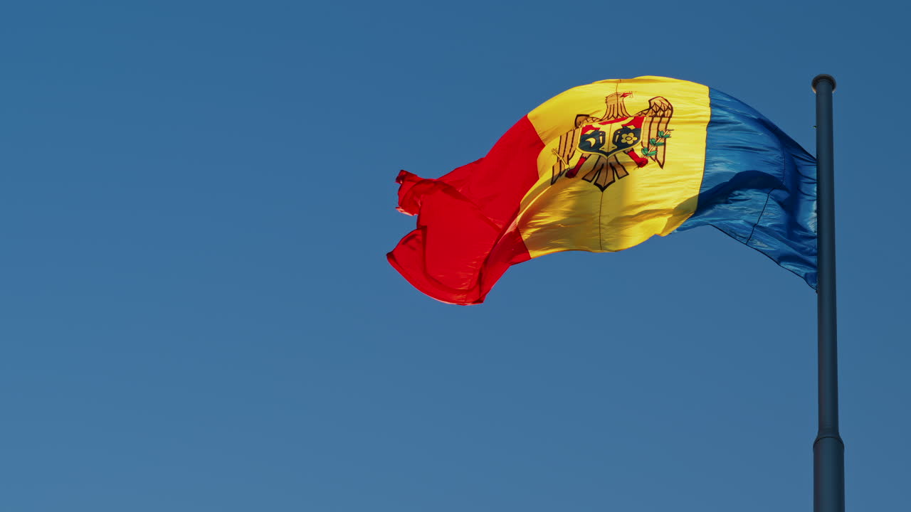 View of the flag of the Republic of Moldova on a blue sky background