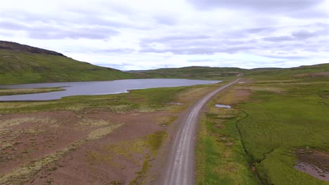discover the enchanting beauty of iceland as a tesla drives through vibrant landscapes, with the drone capturing every breathtaking moment from above.