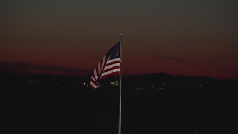 united states flag flying with a sun set background