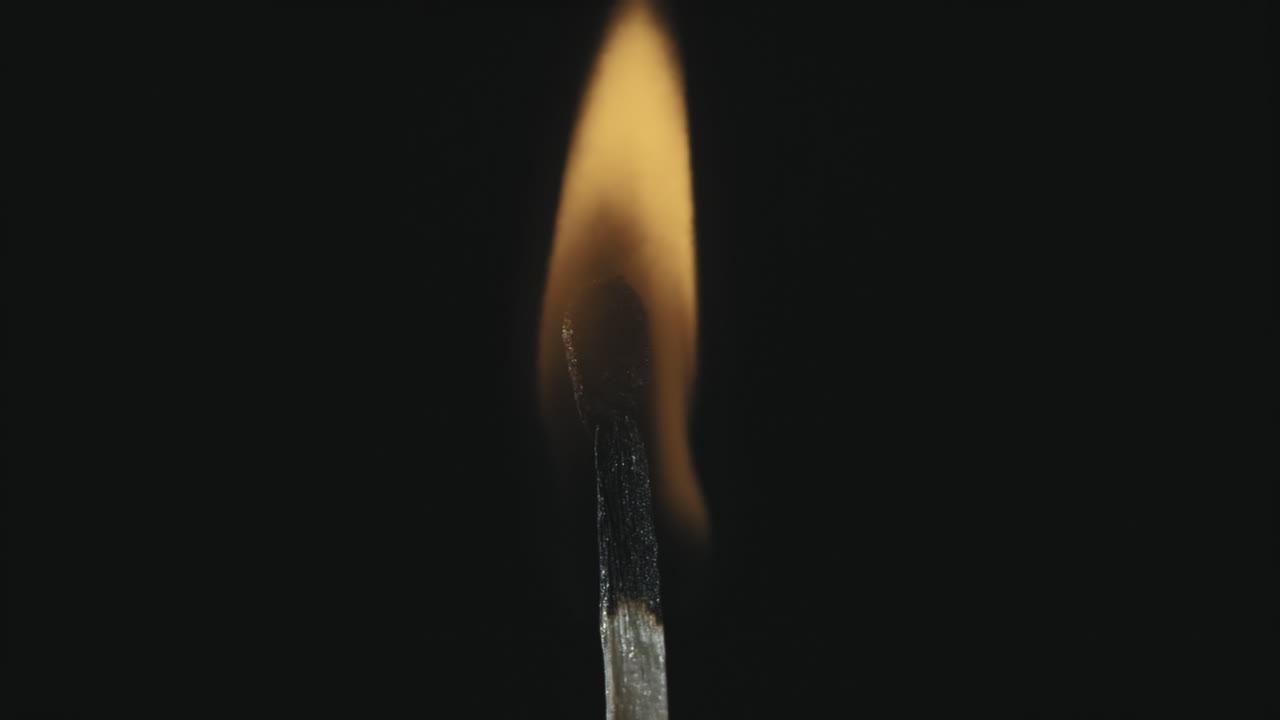 A burning match in the darkness