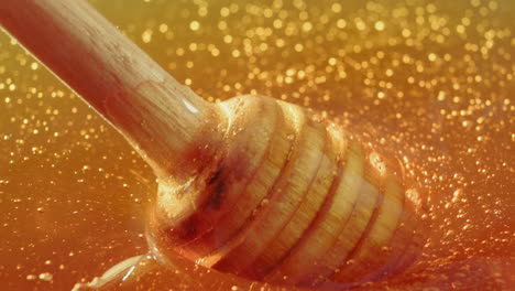 close-up of honey with a wooden dipper