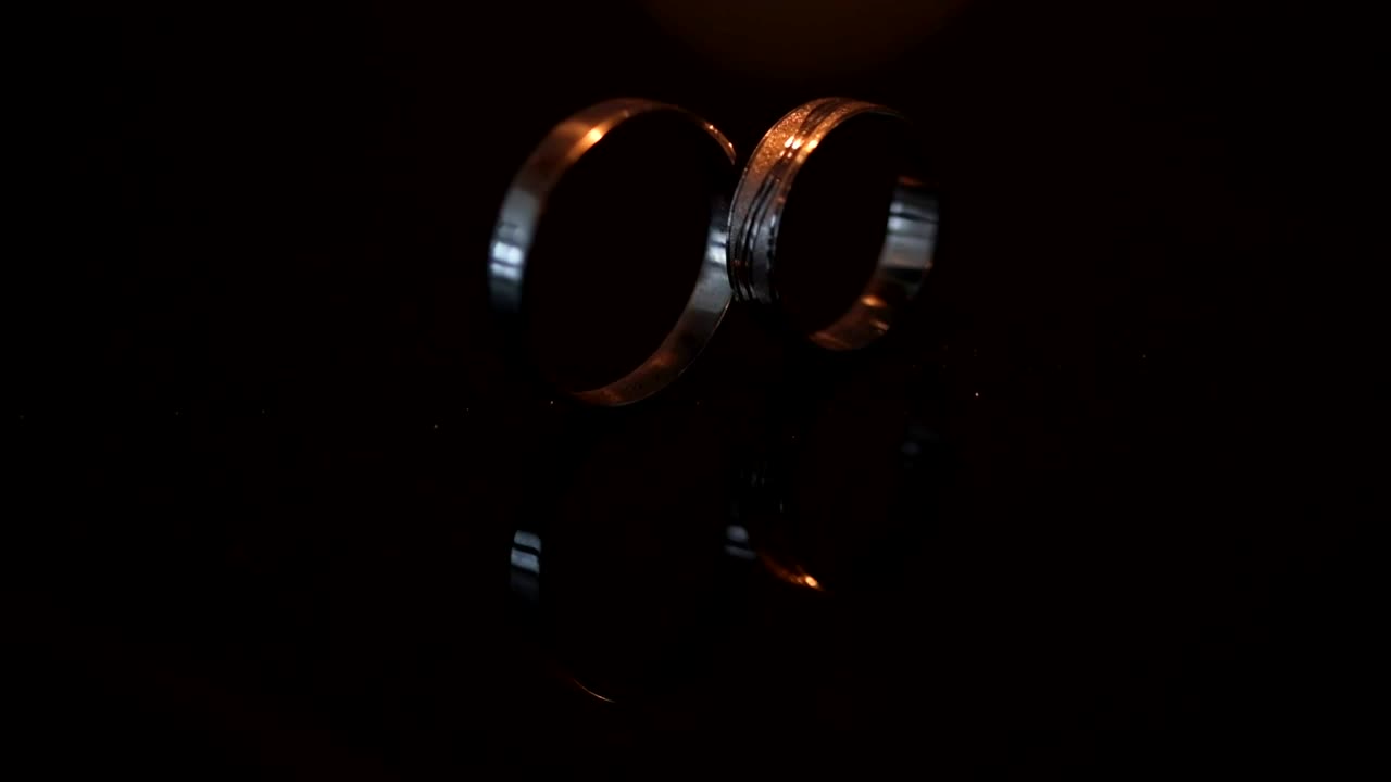 Wedding rings on the table with sparkles