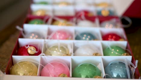 view of shiny, colorful christmas tree balls in a box