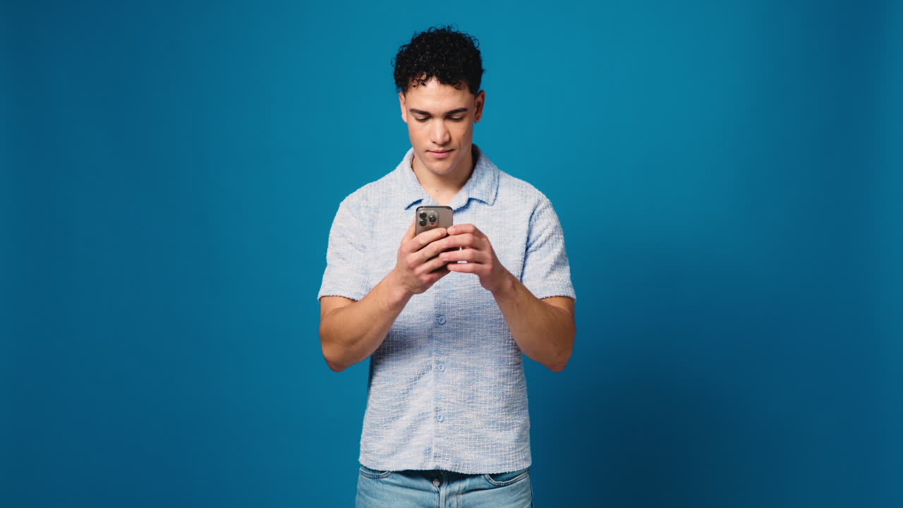 Man using smartphone on blue background