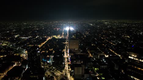 drone-shot-of-diverse-color-fireworks-demonstration-at-mexico-city-zocalo-and-torre-latinoamericana-at-independence-day