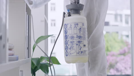 closeup of sanitation worker disinfecting