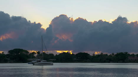 sail boat slowing moving through south florida inlet early in the morning