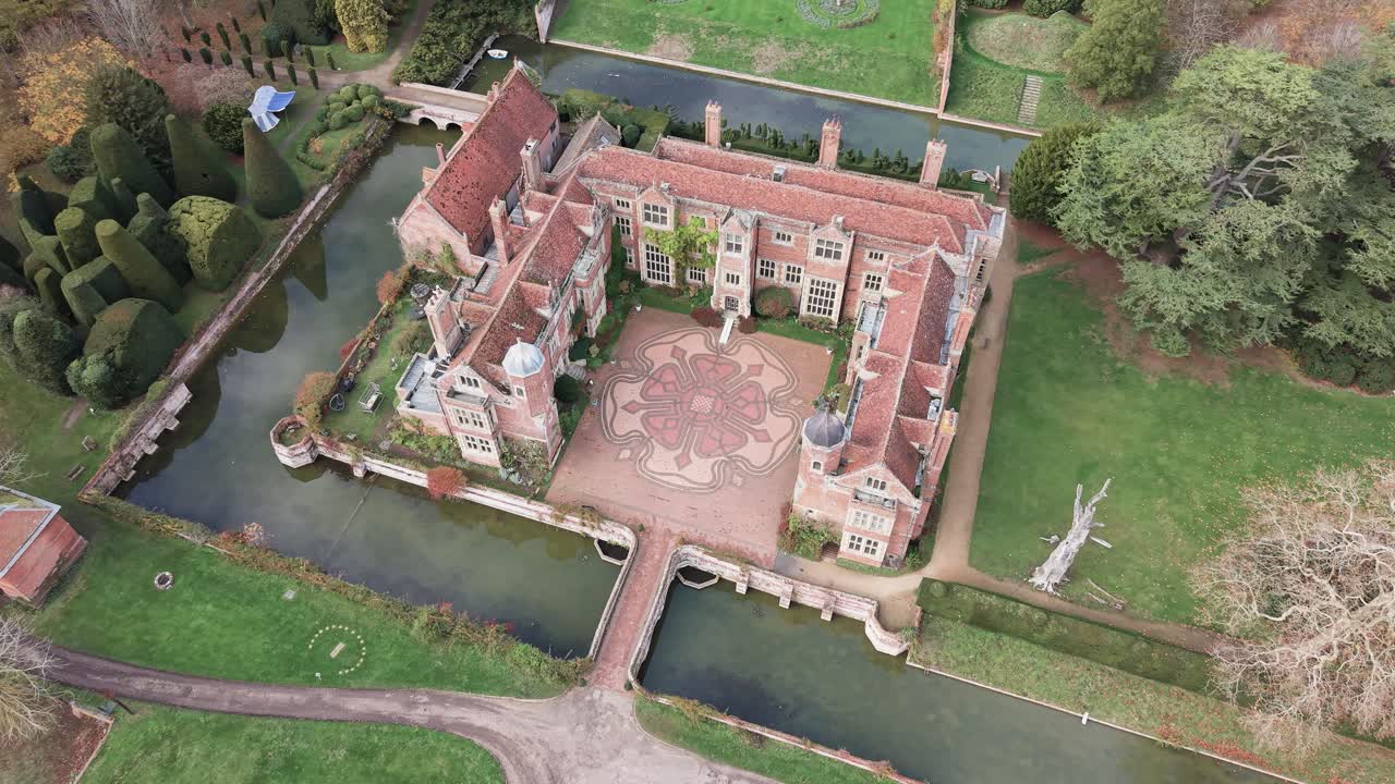 Kentwell Hall, Long Melford, Suffolk, United Kingdom - A Grand Historic Estate is Surrounded by Water, Manicured Gardens, and Expansive Green Grounds - Aerial Drone Shot