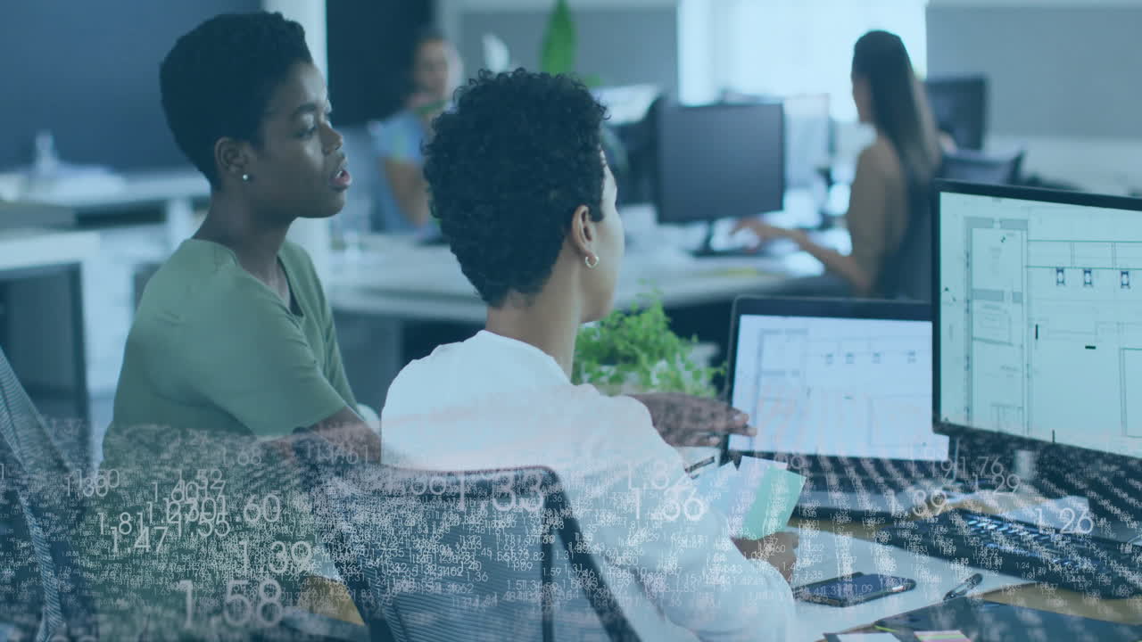 Two women working at office desks with data processing animation overlay