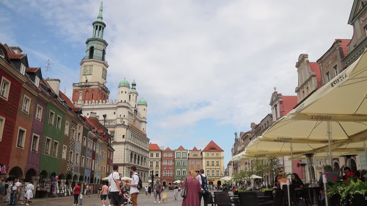 Daytime timelapse of people at old town market square in Poznan, near the city hall.