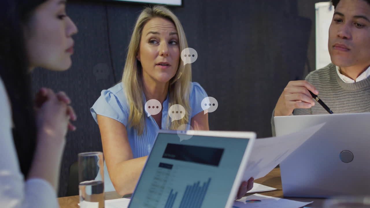 Discussing documents and data, colleagues in business meeting using laptops