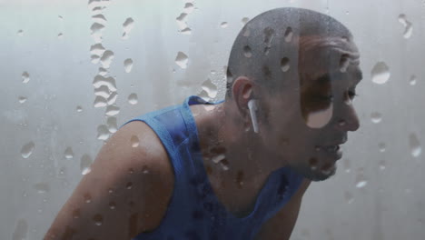 animation of dripping water droplets over male athlete resting after exercise