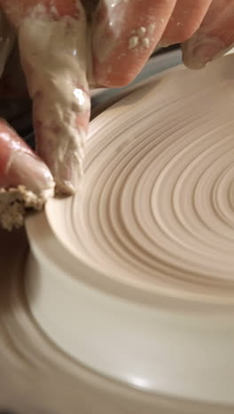 male potter making pot