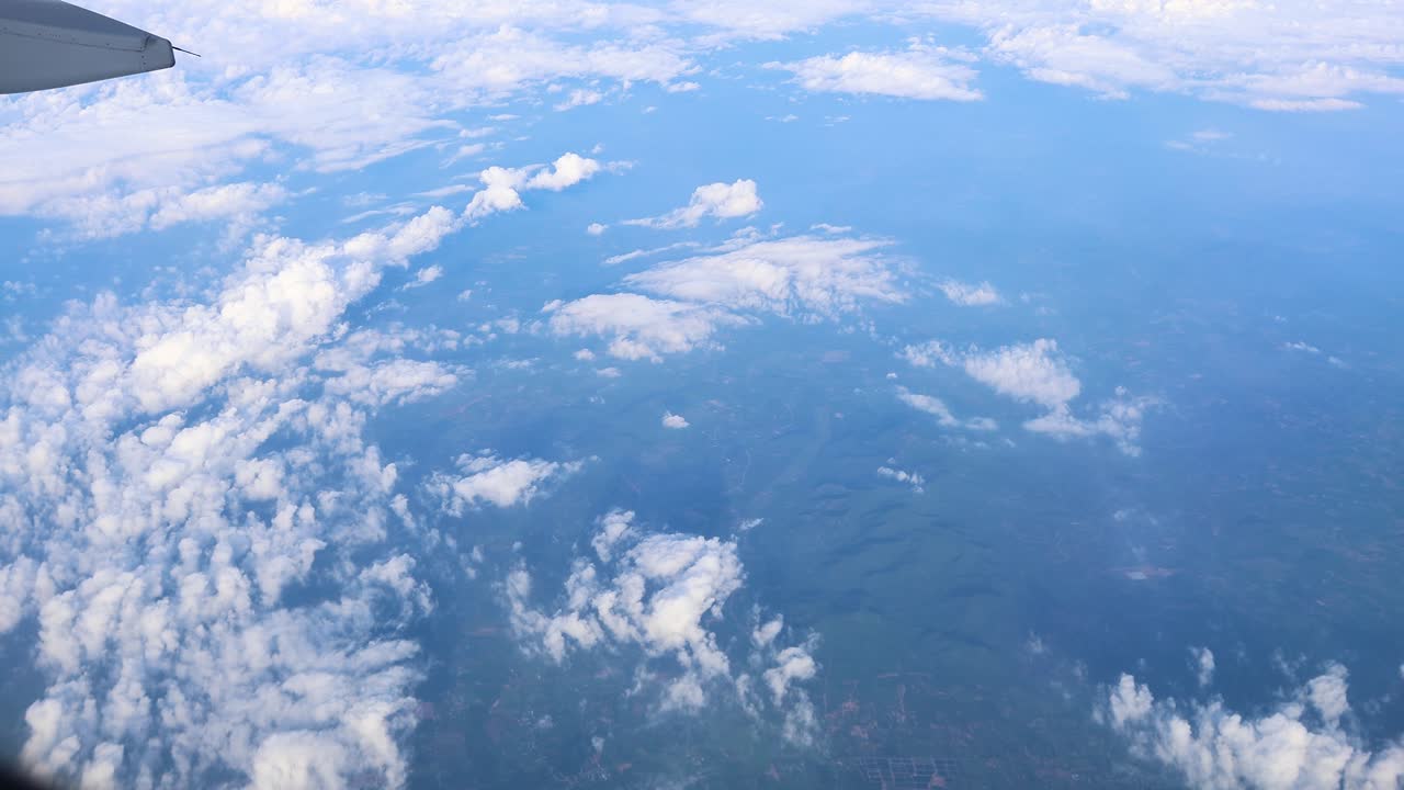 vista aérea de las nubes y el paisaje desde la ventana del avión
