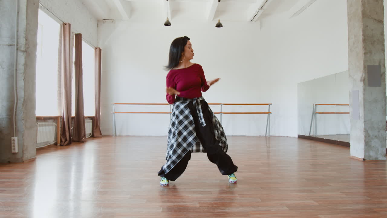 Energetic Woman Dancing in a Bright Studio