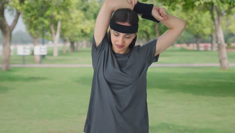 happy indian girl doing arm exercise