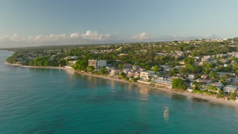 Cinematic-orbit-shot-of-coastal-houses,-in-golden-hour