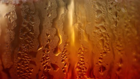 close-up of water droplets forming on chilled drink glass surface