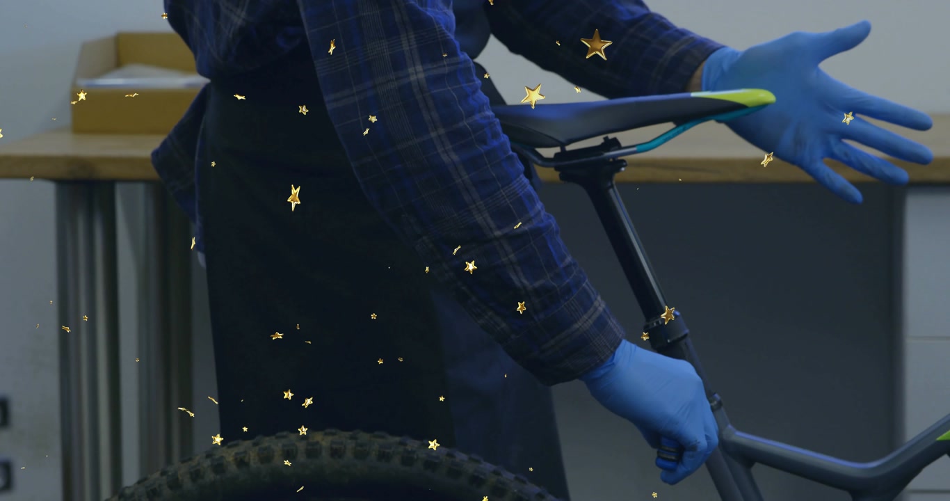 Bike mechanic gripping bike pressing dropper post lever testing saddle height adjustment