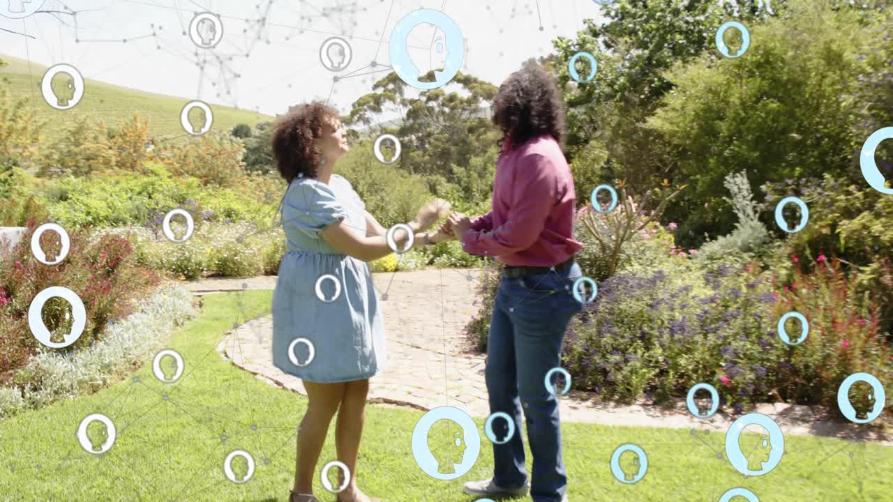 Couple holding hands walking path to lawn, woman touching arm causing marketing bubble network