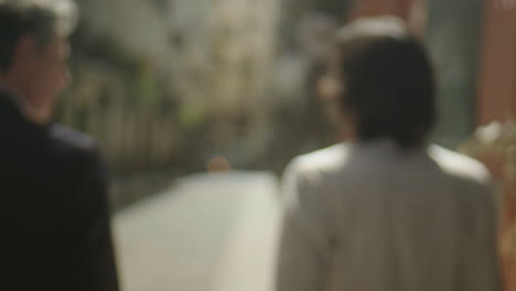 blurred people walking on a city street