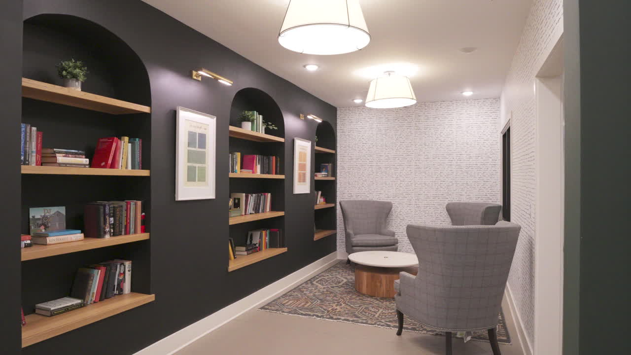 Modern Library Lounge with Arched Built-in Shelves and Cozy Chairs