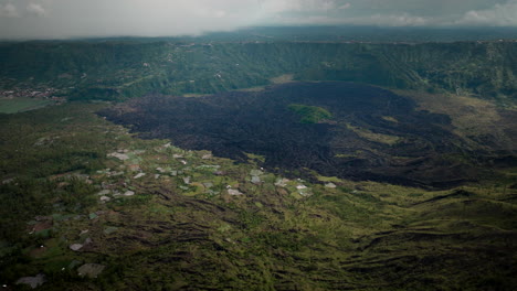 Dark-lava-fields,-rural-Indonesian-scenery,-active-volcanic-mountain