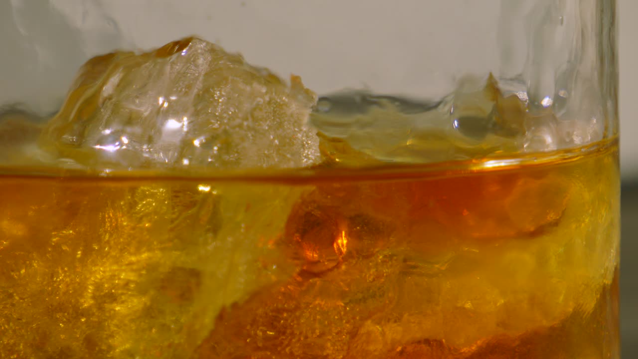 Slow Pan Across Whiskey in Tumbler with Fresh Cold Ice Cubes. Refreshing Alcoholic Drink
