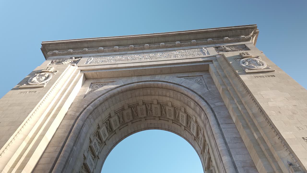 Bucharest city landmark Arch of Triumph architecture Pan Up reveal