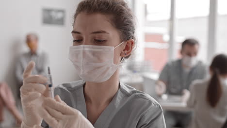 portrait of female doctor with syringe