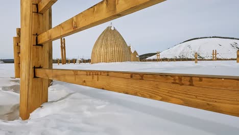 National-Yakut-buildings-from-behind-the-fence,-the-camera-climbs-up-the-fence