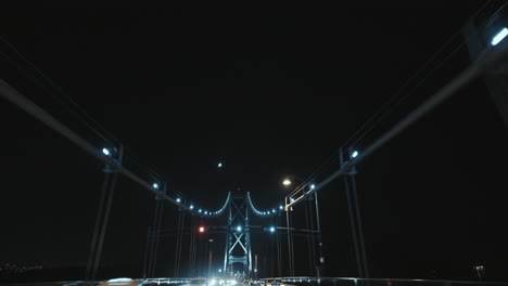 Wide-low-angle-shot-of-Lions-Gate-Bridge-suspension-ropes-and-Tower-at-Night,-Vancouver,-Canada