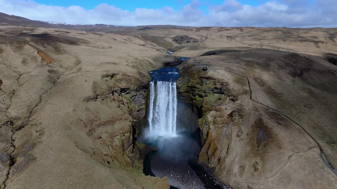 aerial view of skogafoss waterfall with rainbow travel tourist destination in Iceland drone wide angle