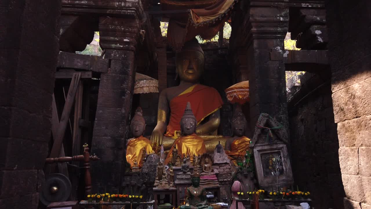 Champassak / Laos - Feb 13: Vat Phou – ruined Khmer Hindu Mountain Temple. Buddhist altar buddha statues. Holy place for prayer. Buddhism religion. UNESCO World Heritage. Ancient temple complex. Slow