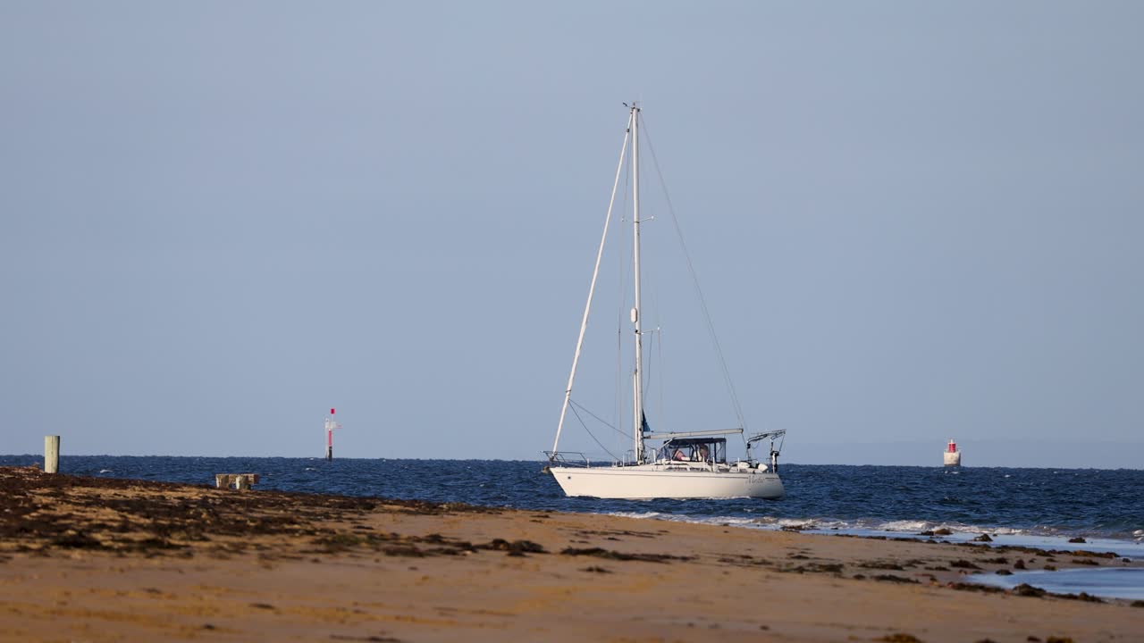Sailboat moving along the Bellarine coastline