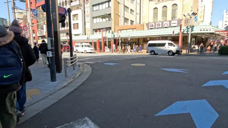 people walking across a city street crosswalk