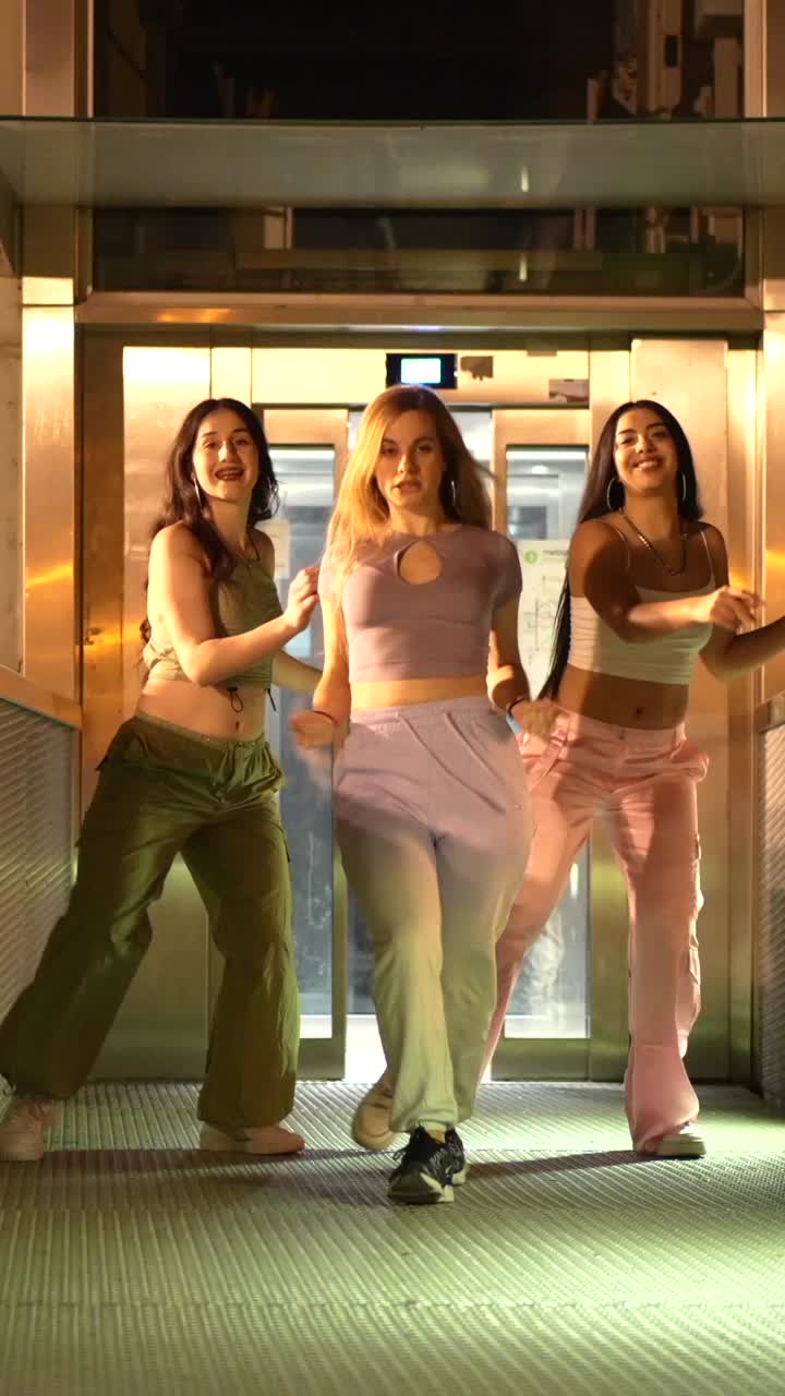 Three women dancing in an elevator