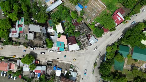 bird's eye top down view of bustling three-way intersection in philippine rural town