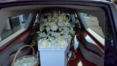 closeup shot of a funeral casket in a hearse or chapel or burial at cemetery