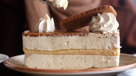 closeup of a slice of delicious cake with whipped cream and caramel