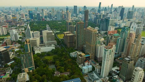aerial view of ploenchit junction with cars traffic skyscraper buildings. bangkok city in downtown at night, thailand