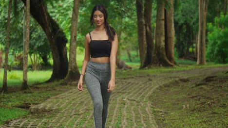 the tropical ambiance of the park enhances the exercise routine of a young girl in sports attire